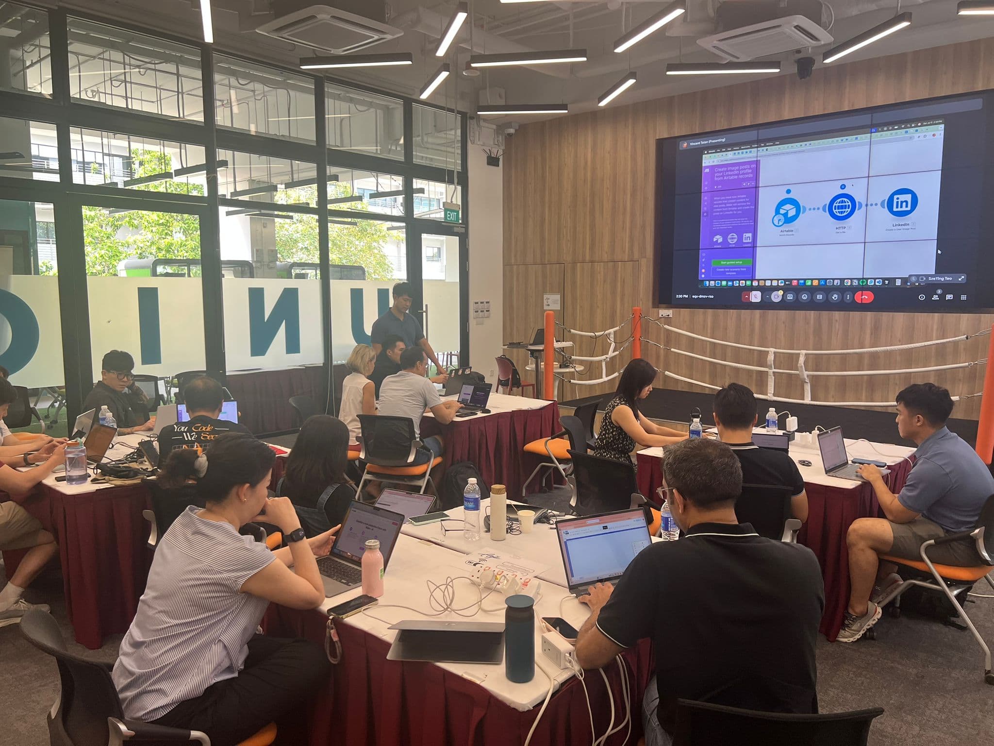 Workshop participants actively coding and learning with laptops